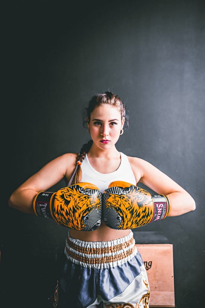 confident young woman in boxing gloves