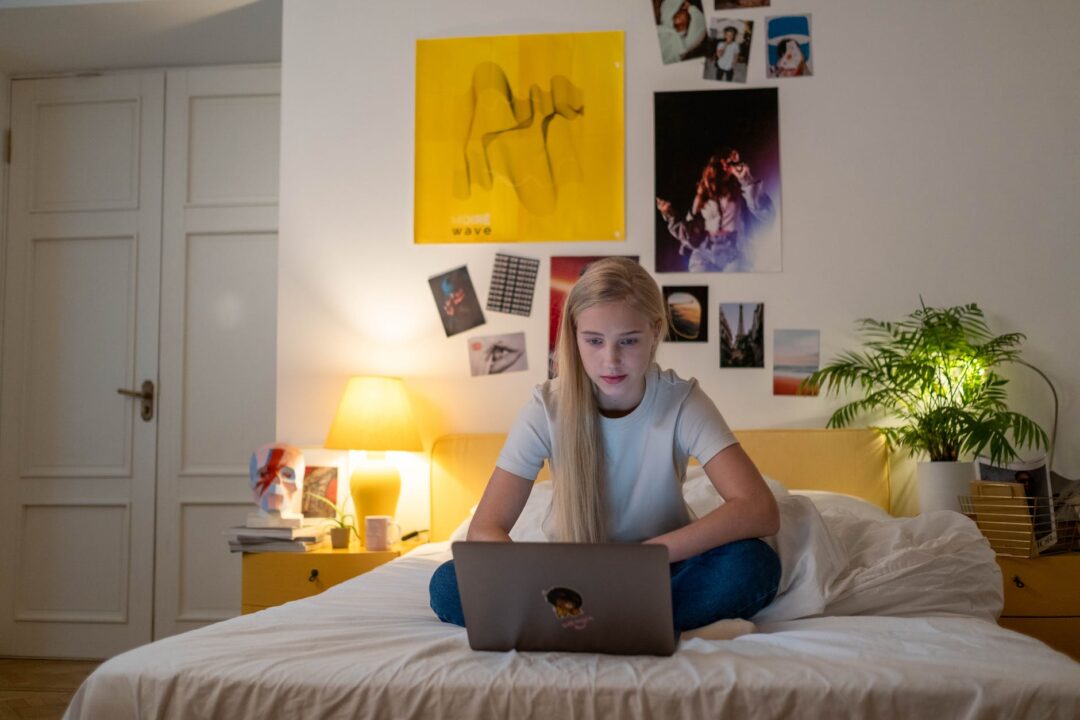 a female teenager using her laptop
